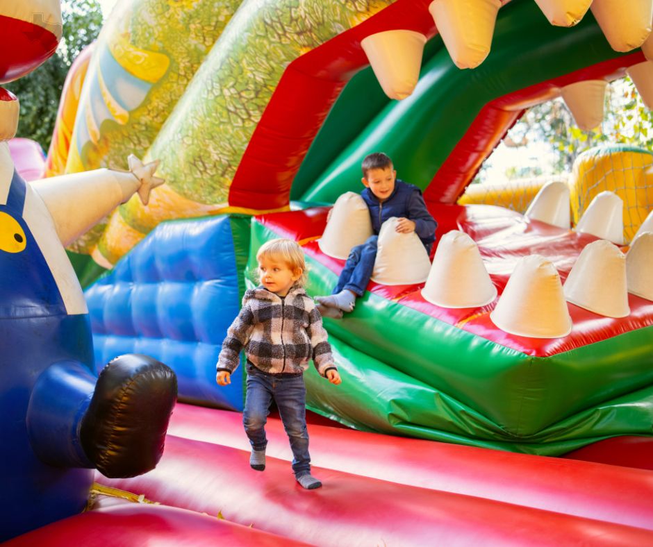 Kids playing in a festival bounce house.