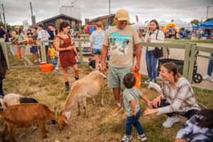 Families enjoying live entertainment and fall activities at DFW Fall Fest in Frisco, Texas.