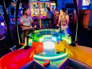 Guests enjoying a multiplayer arcade game at Dave & Buster's Frisco