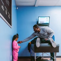CTC Chiropractic team member welcoming a young patient in Frisco