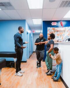 A chiropractor speaking with a family at CTC Chiropractic in Frisco